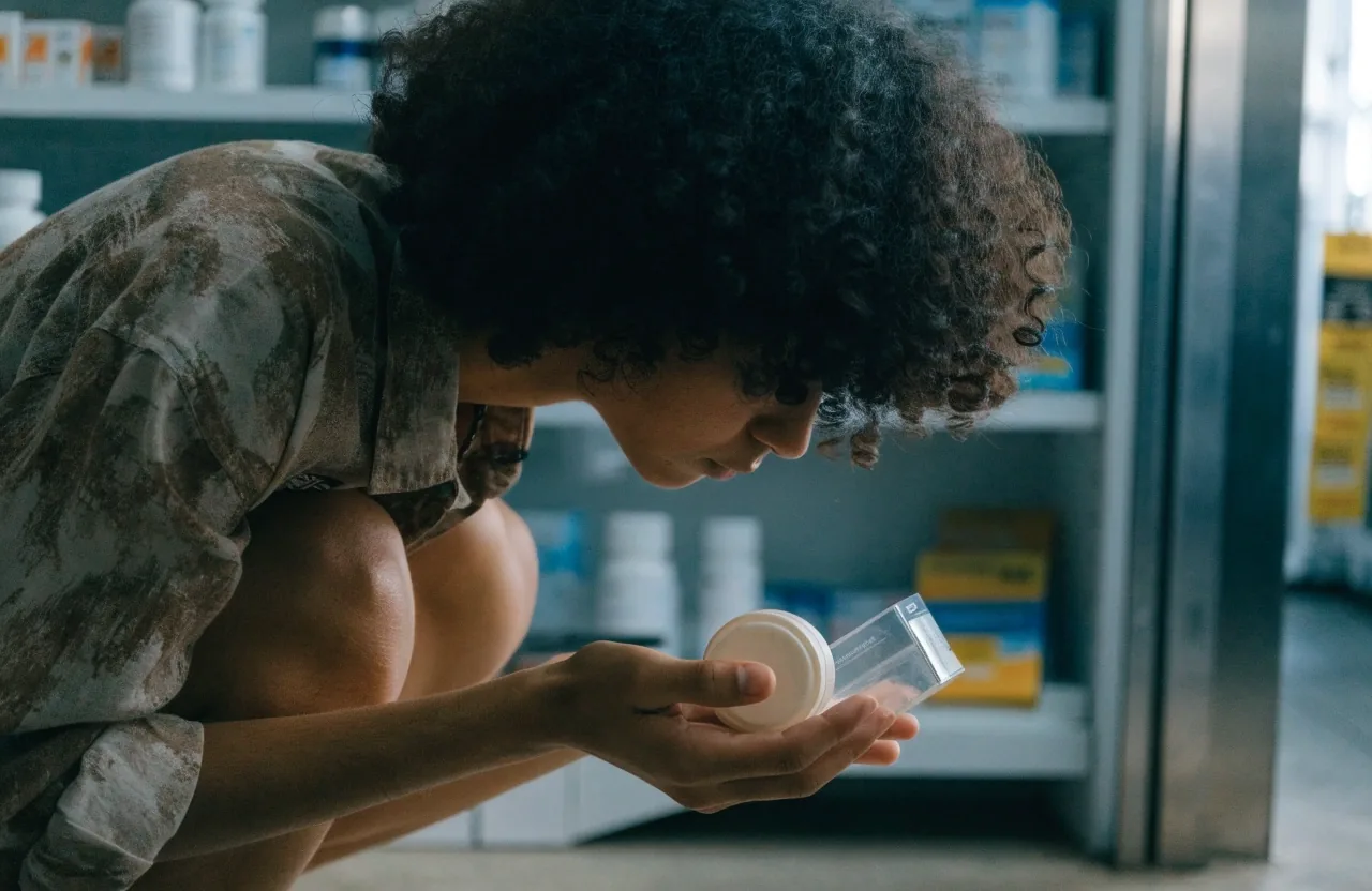 Two hands sorting unbranded everyday supplement formats into columns on a stone counter